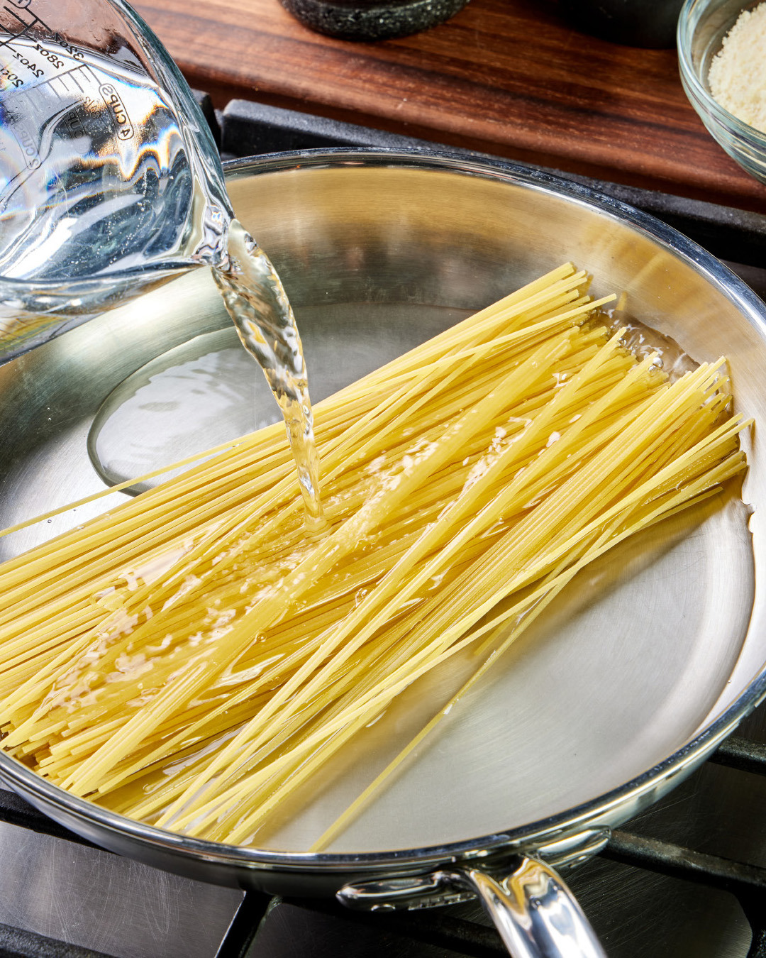 1. In a 12-inch skillet, add 12 ounces of bronze-cut spaghetti, placing the noodle strands parallel to each other in the center of the pan.
